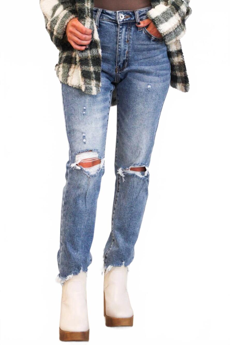 NEW SPECIAL A distressed mid rise straight leg denim jeans in medium wash